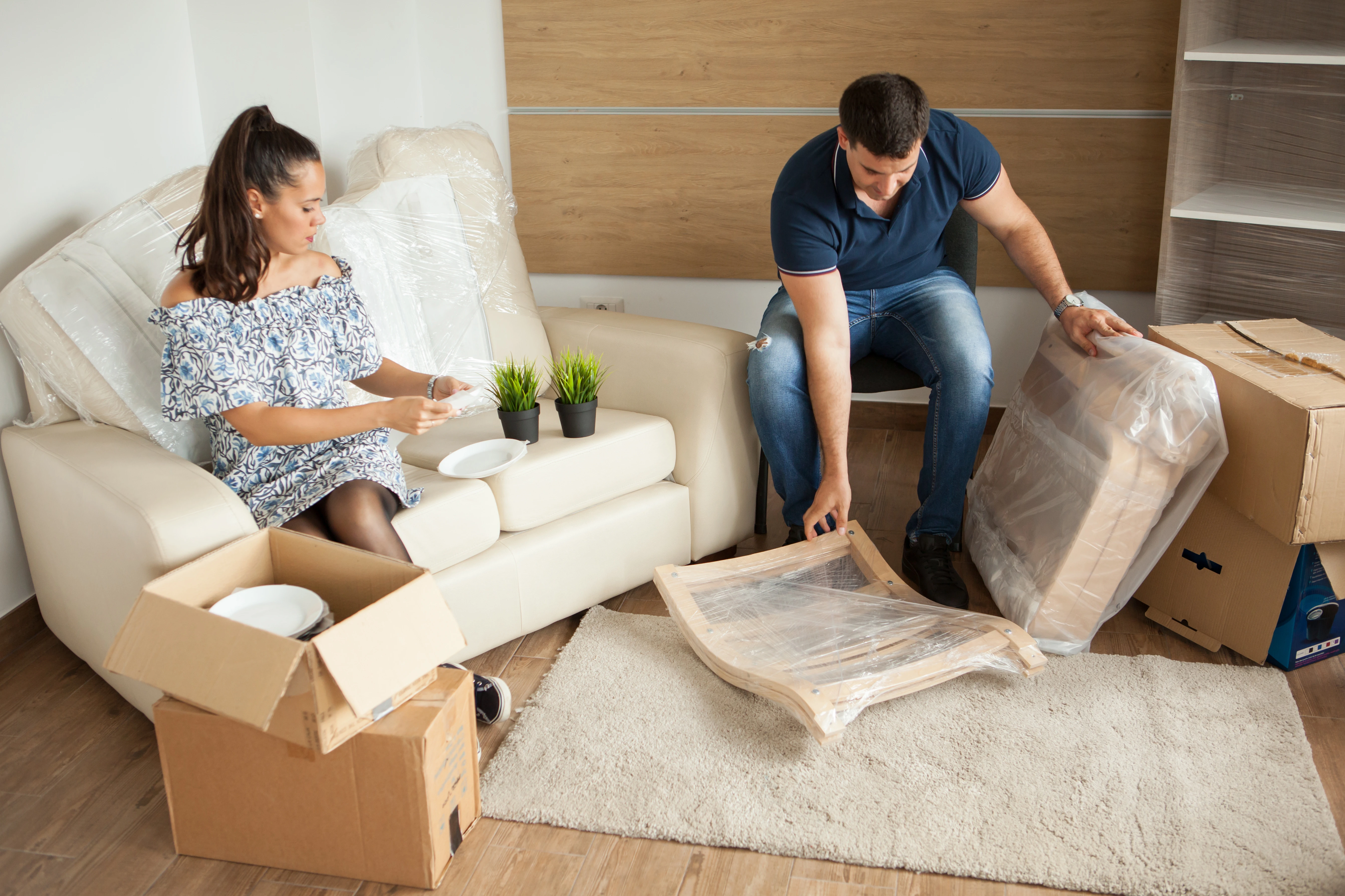 Young Couple Moving New Home Unpacking Carboard Boxes Almost Done Moving Ezgif.com Crop 1