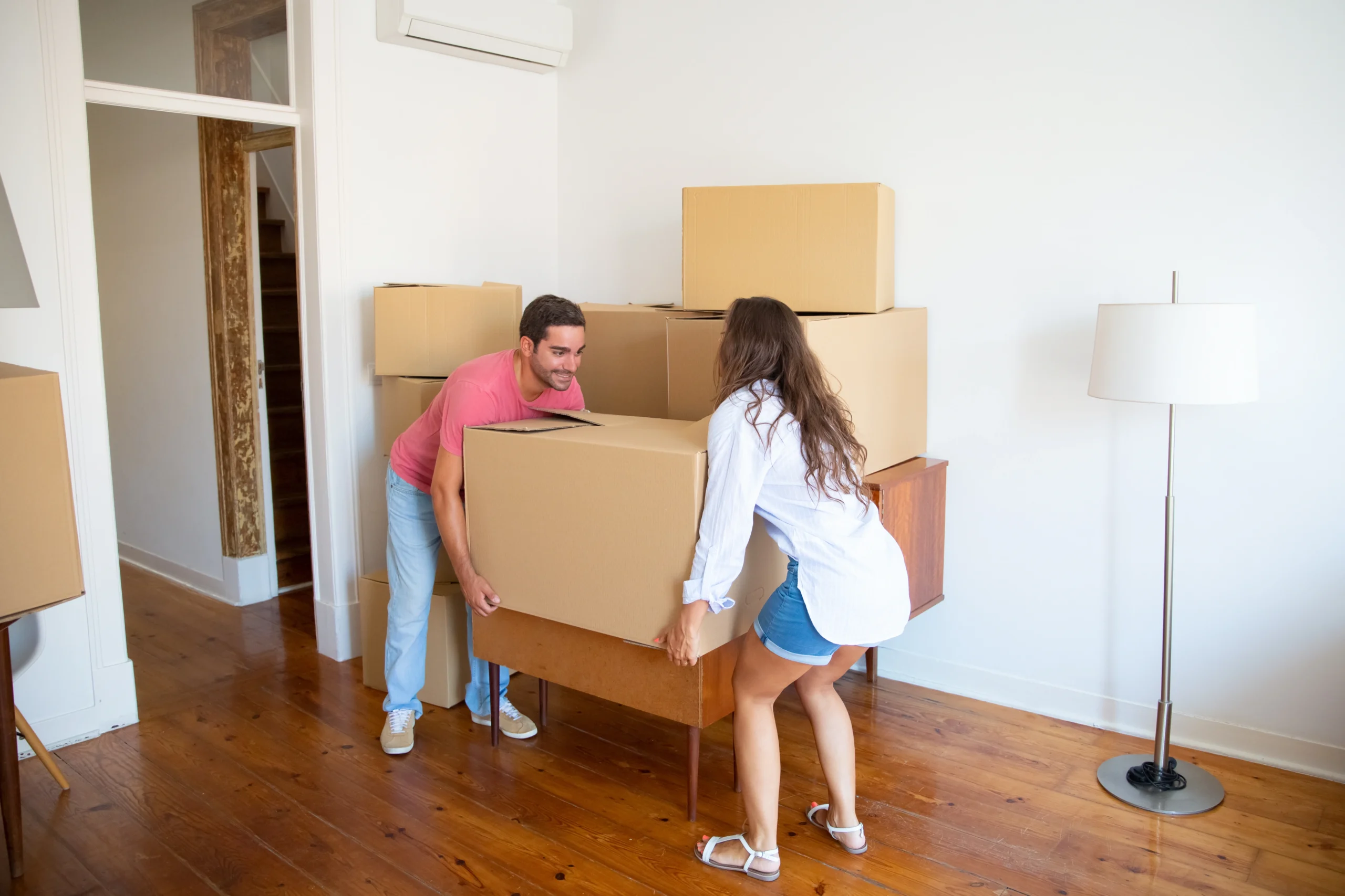 Young Family Couple Moving Into New Apartment Carrying Carton Boxes Furniture Ezgif.com Crop